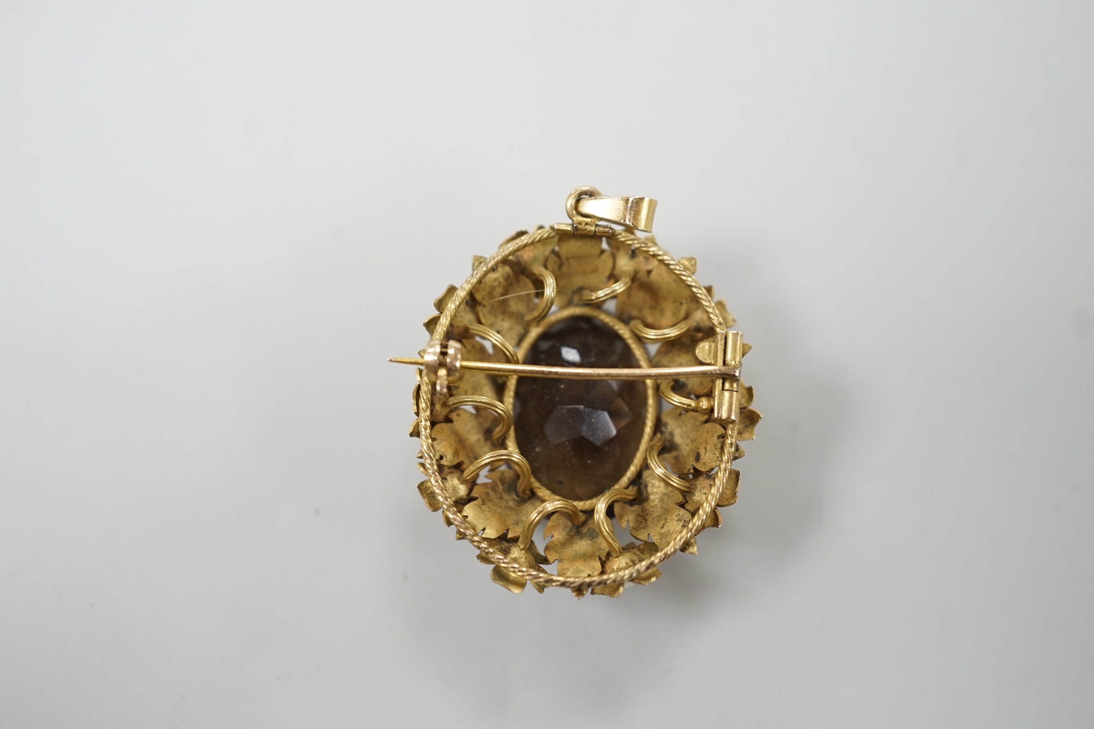 A yellow metal, oval cut brown quartz and cultured pearl set pendant brooch, 34mm, gross weight 12.8 grams.